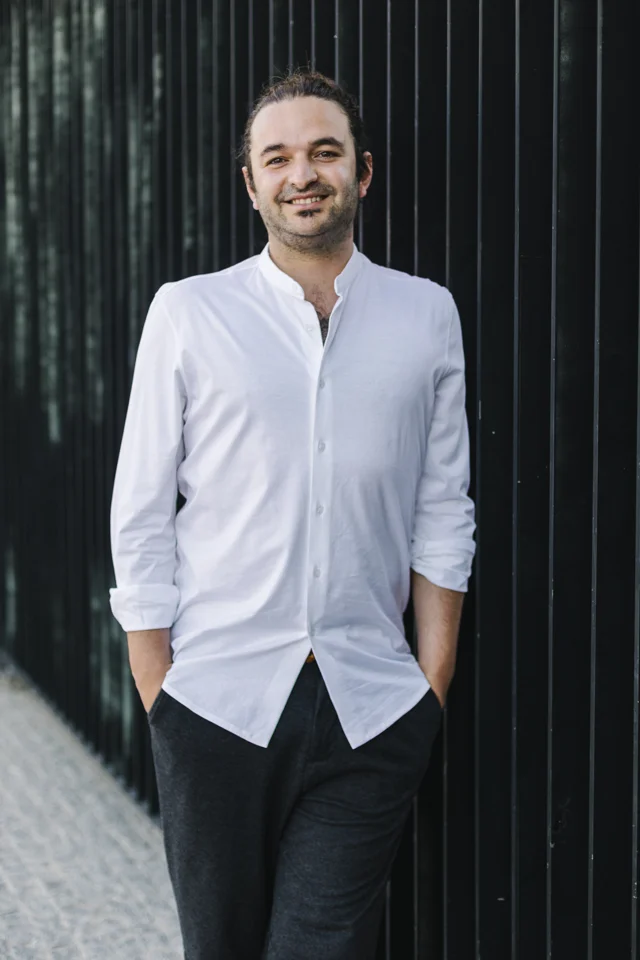 Davide Amato standing outdoors with his hands in his pockets